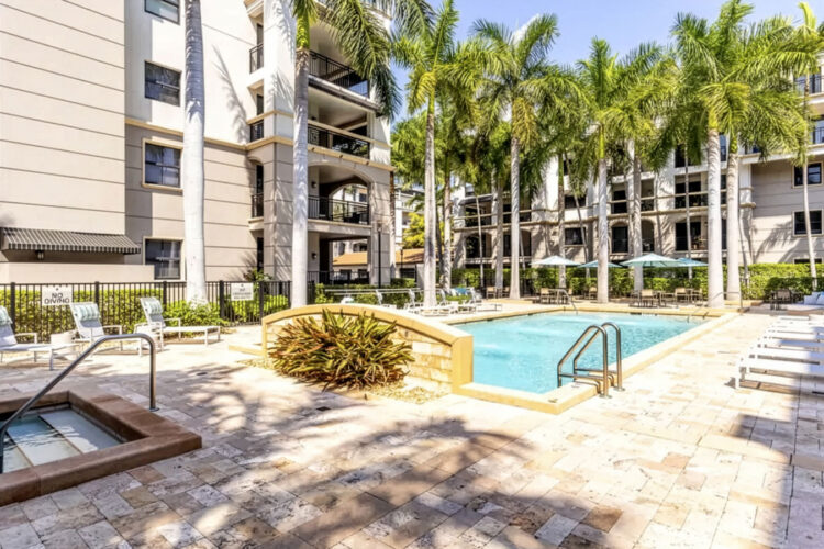 Pool area with fountain and tropical landscaping at Heritage at Boca Raton