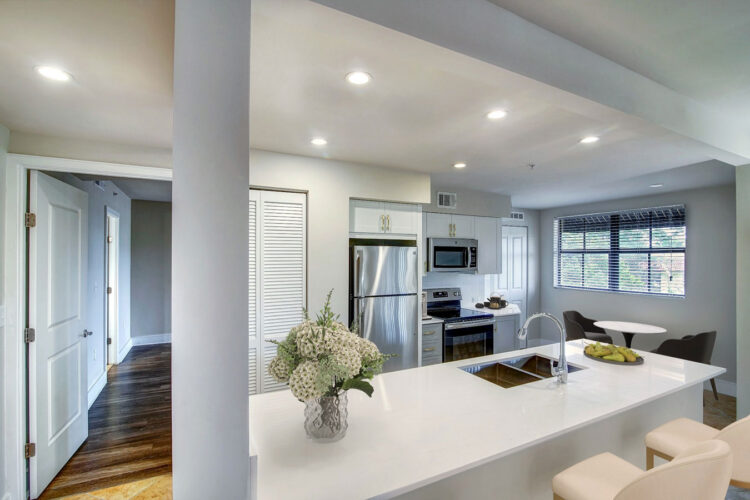 Apartment kitchen with island and pendant lighting at Heritage at Boca Raton