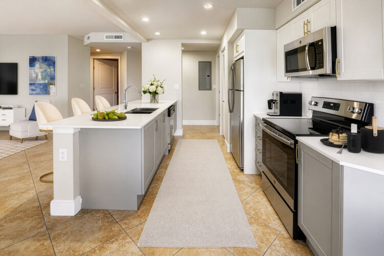 Renovated white kitchen with stainless steel appliances at Heritage at Boca Raton