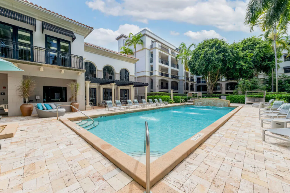 Resort-style swimming pool and apartment courtyard at Heritage at Boca Raton